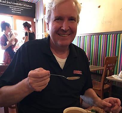 Tom Veasy enjoying some of his favorite things - delicious coffee and food - in a new restaurant.