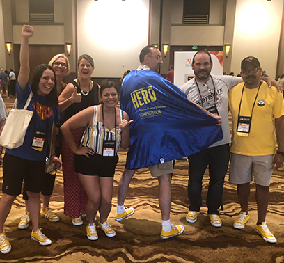 Eric wearing his HERO cape with fellow Computrition employees at the annual AHF conference.